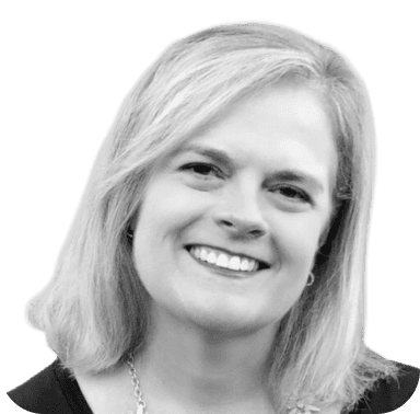 Black and white headshot of a smiling woman with shoulder-length hair against a green background.