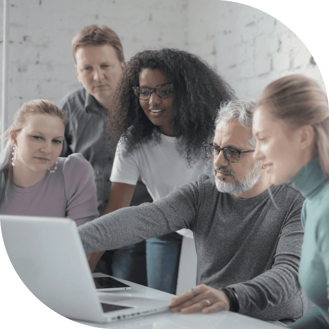 Diverse group of five professionals looking at a laptop screen together.