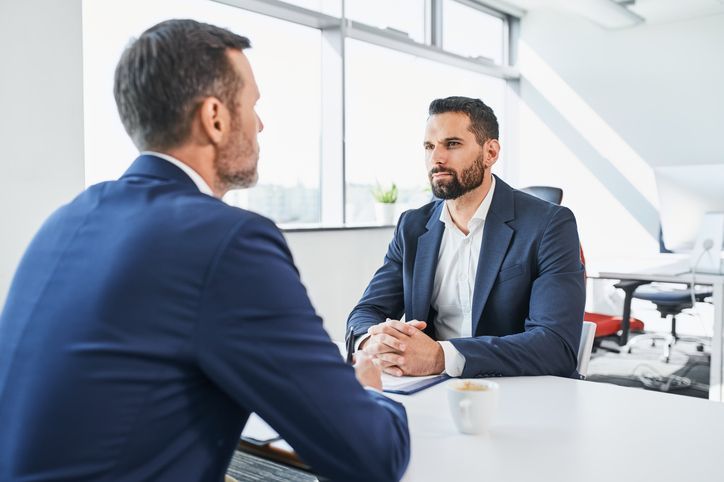 Negotiation of two businessmen in office.